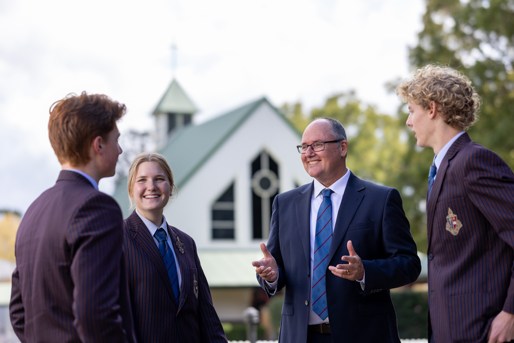 Toowoomba Anglican School Principal Nick Johnstone chats with TAS Secondary students in front of the beautiful Chapel of St Aidan at the TAS campus.